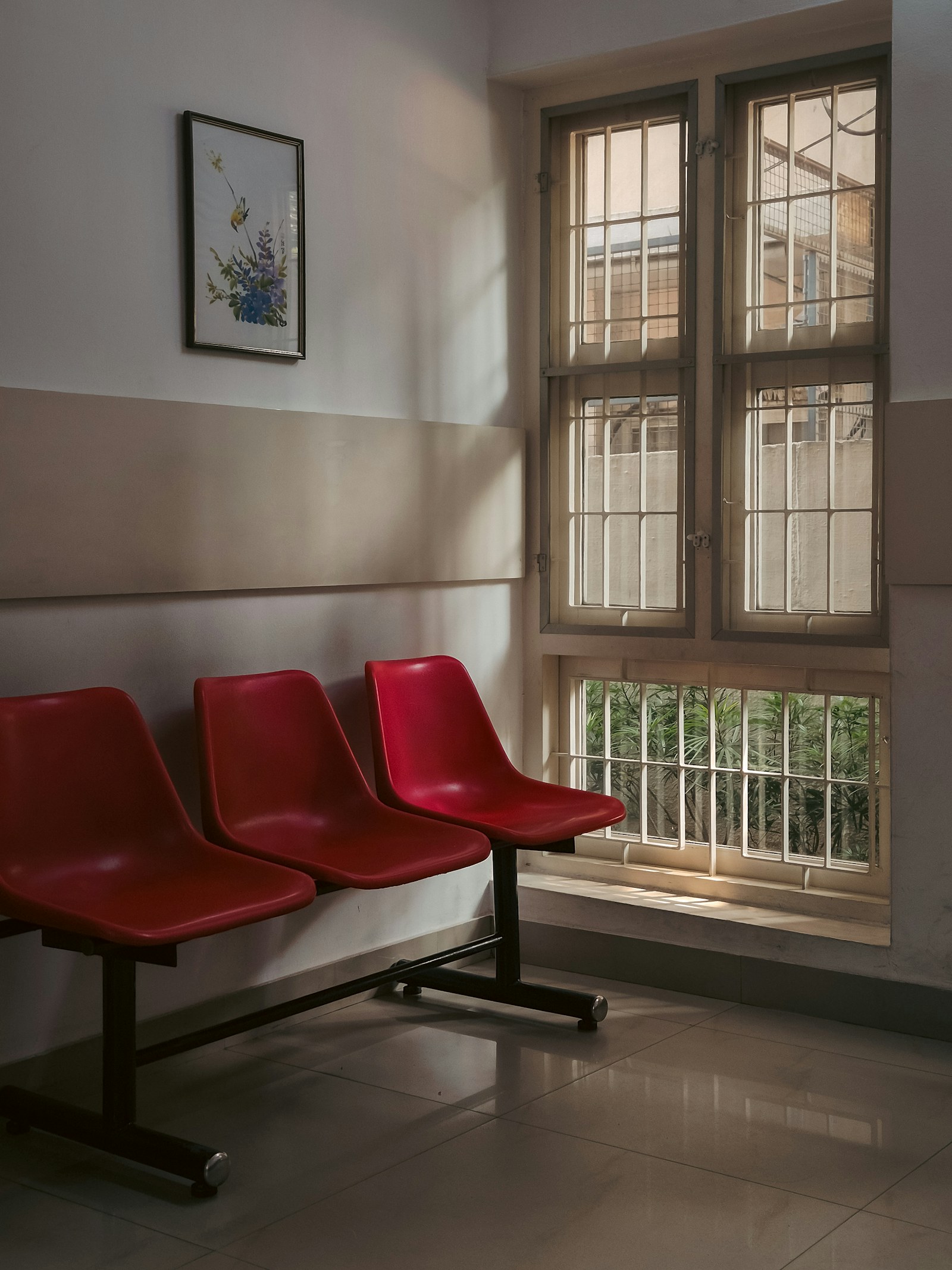 Red chairs in a clinic waiting room