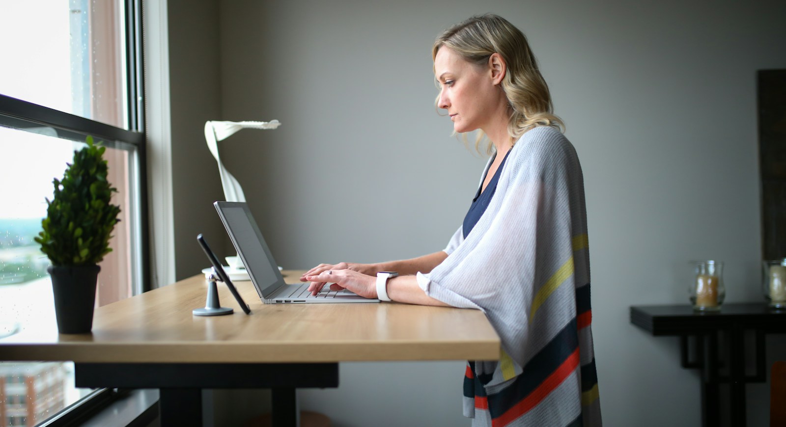 Person sitting upright at a desk using a laptop